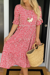 Robe midi élégante Olyndra London LIVIA à pois rouges avec coupe fluide et détails sophistiqués.