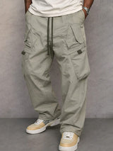 Pantalon utilitaire George d'Olyndra London en tissu robuste, couleur gris foncé, avec poches pratiques et coupe confortable.